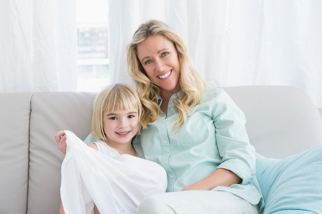 Mother sitting on the couch with her daughter 