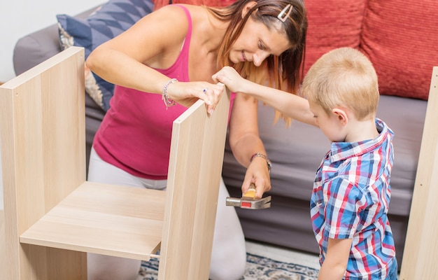 mother and son are building the furniture