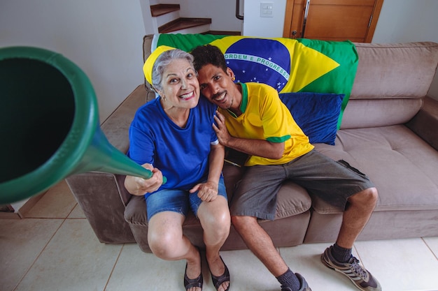 Mother and Son Celebrating the Cup in the living room watching TV cheering for Brazil