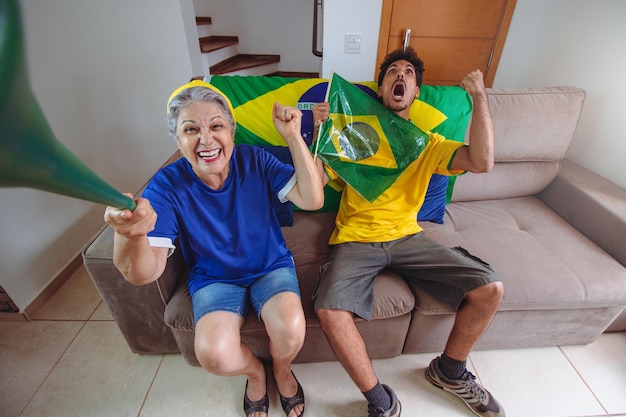 Mother and Son Celebrating the Cup in the living room watching TV cheering for Brazil