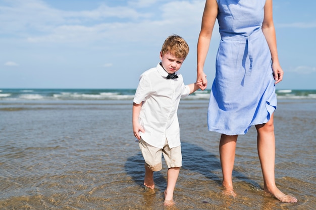 Mother and son chilling at the beach