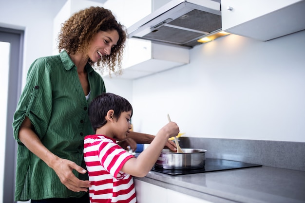 Mother and son cooking in kitchen