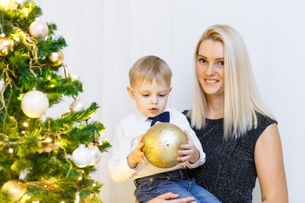 Mother and son decorating christmas tree