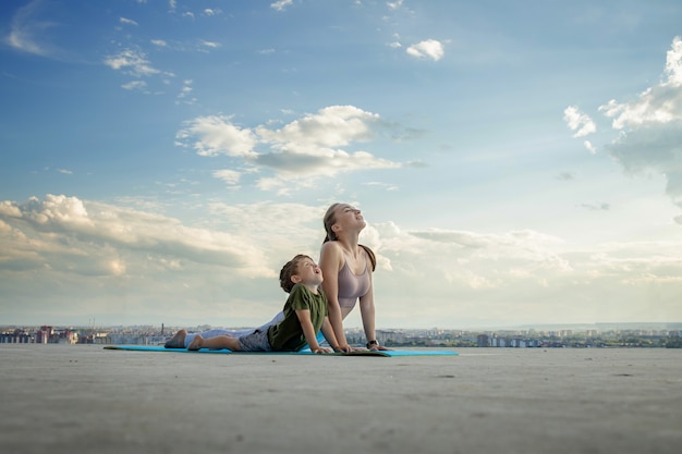 Mother and son doing exercise on the balcony