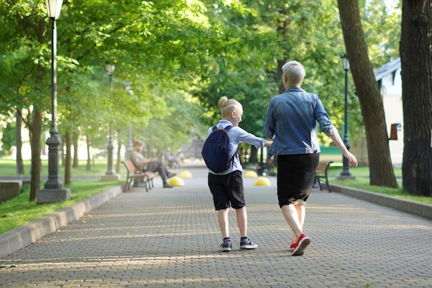 Mother and son going to school holding hands