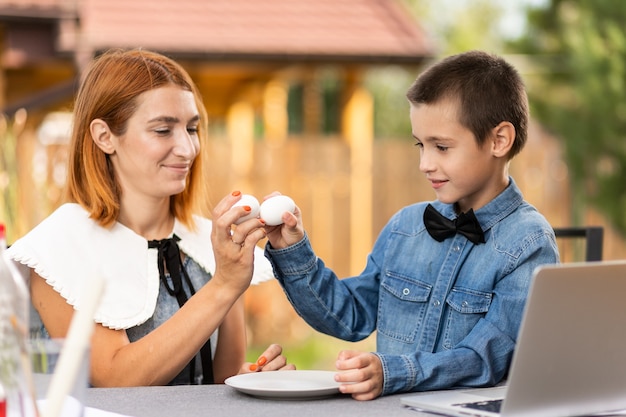 Mother and son have fun and beat eggs on Easter morning,. Easter for the whole family. Has fun while preparing for Easter.