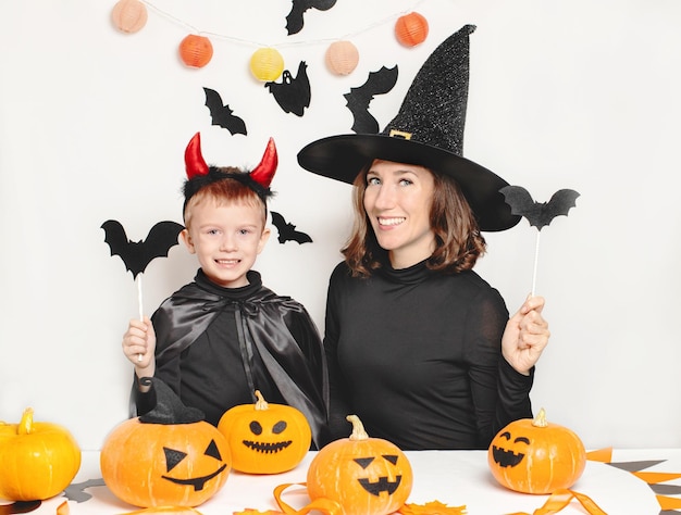 Mother and son have fun and celebrate Halloween in a witch and devil costume Happy Family celebrating for Halloween