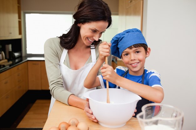 Mother and son having fun preparing a cake