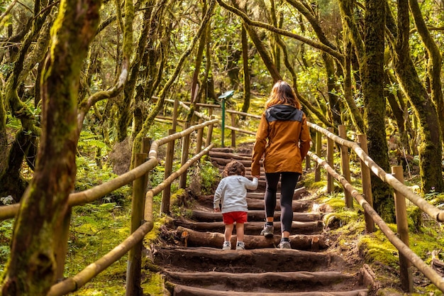 Mother and son hiking on a path in the Garajonay natural park on La Gomera Canary Islands