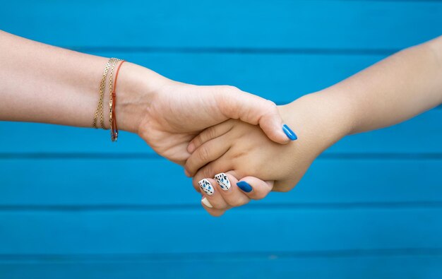 Mother and son holding hand in hand