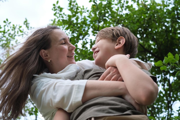 Mother and son in a playful wrestle at the park showcasing the joy of family sports