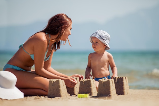 Mother and son playing on the beach