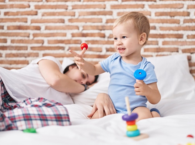 Mother and son playing on bed and sleeping at bedroom