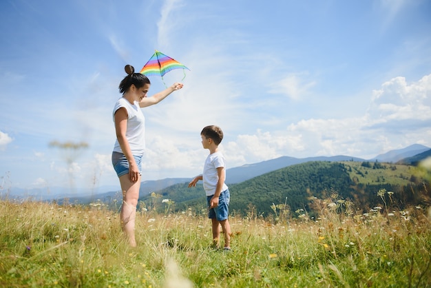 Mother and son playing with a kite