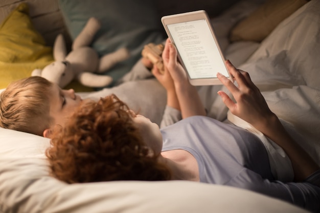 Mother and Son Reading Fairytales in Bed