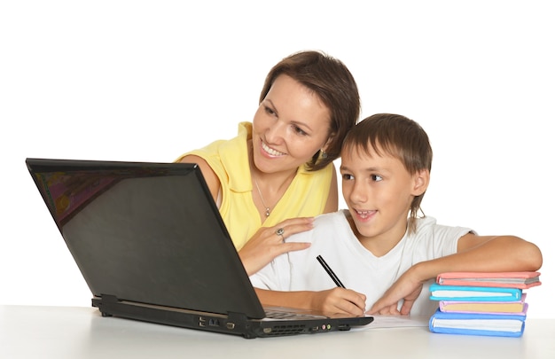 Mother and son studying together at table