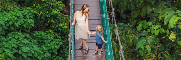 Mother and son at the suspension bridge in kuala lumpur malaysia banner long format