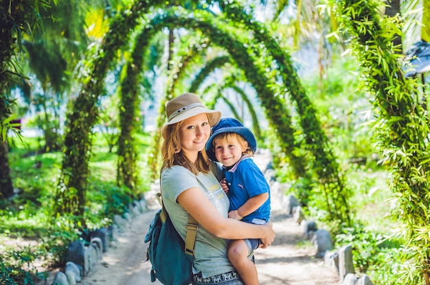 Mother and son in a tropical garden