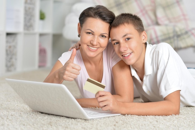 Mother and son using laptop online shopping concept