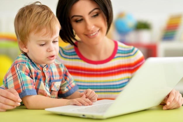 Mother and son using laptop together