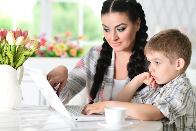 Mother and son using laptop