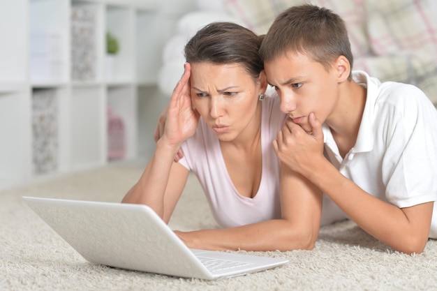 Mother and son using laptop