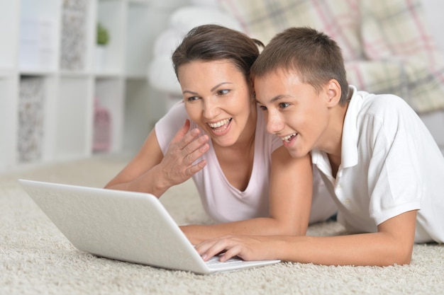 Mother and son using laptop