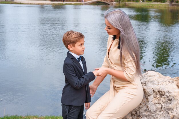 Mother and son walk in the Park by the lake