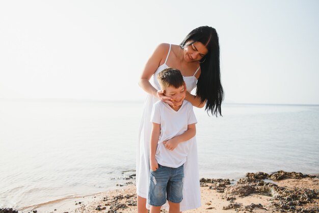 Mother and son walking by the beach