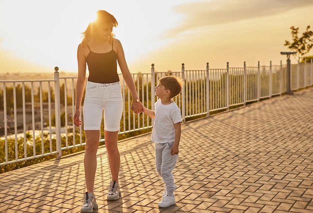 Mother and son walking in summer park