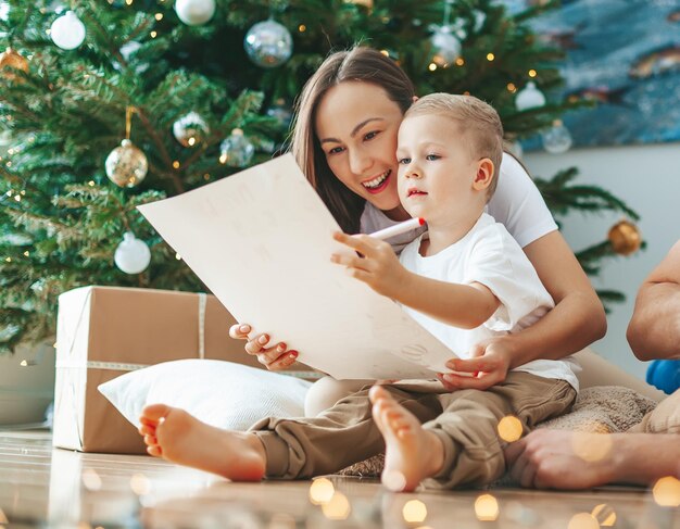 Mother and son writing a letter to Santa Claus