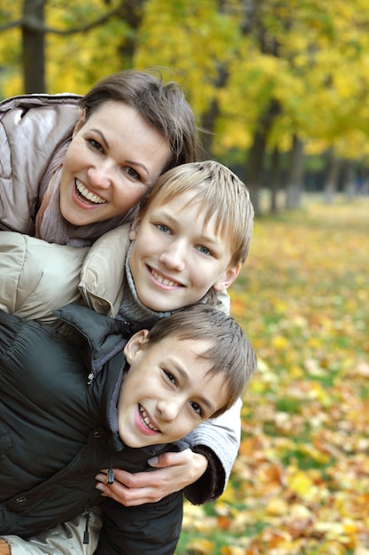 Mother and sons in the autumn park