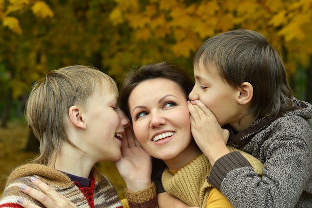 Mother and sons in the autumn park