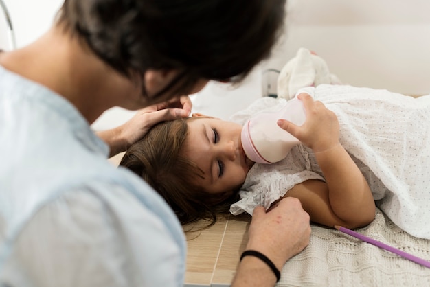 Mother soothing her daughter to sleep