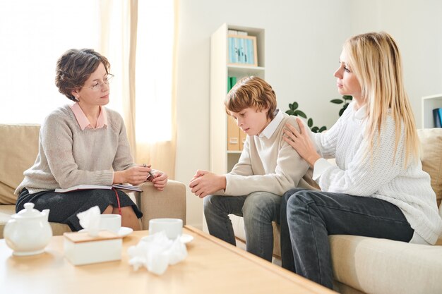 Mother supporting son at therapy session