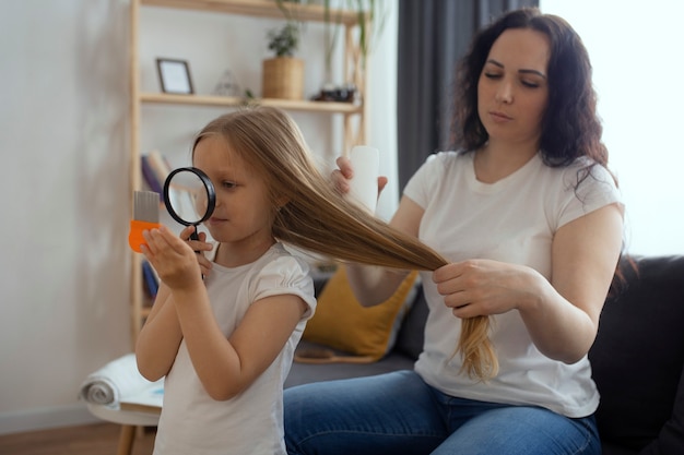 Mother taking care of child with head lices