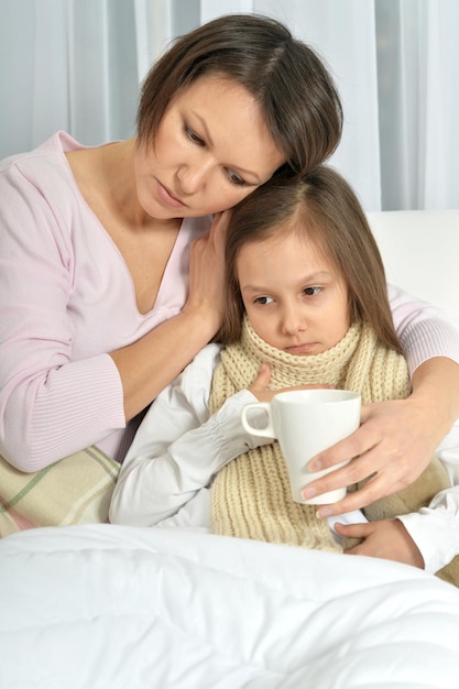 Mother taking care of daughter