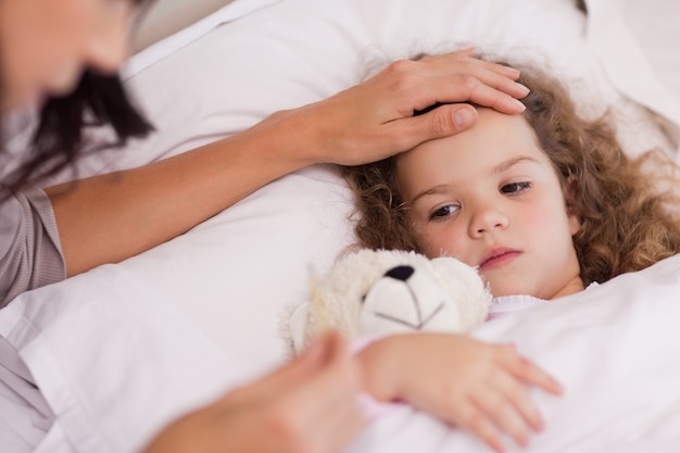 Mother taking care of her ill daughter