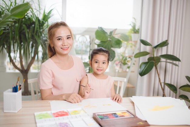 Mother teaches her child how to draw