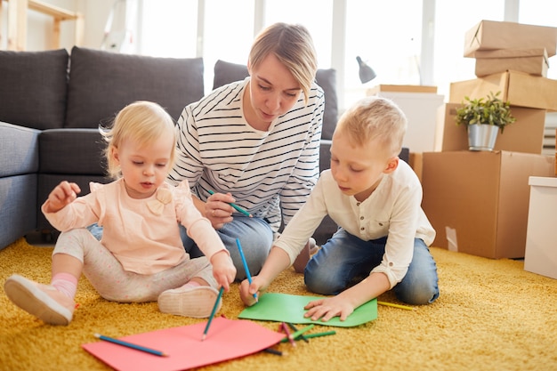 Mother teaching children to draw