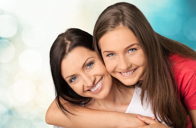 Mother and teen daughter  on background