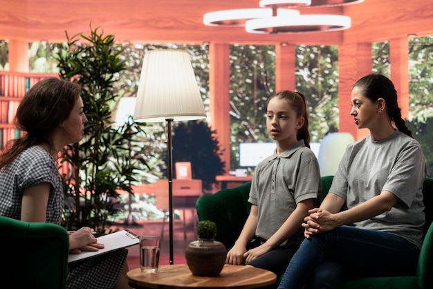 Mother and teenage daughter engaging in a confidential therapy session