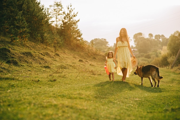 mother walk with his little daughter, and their dog