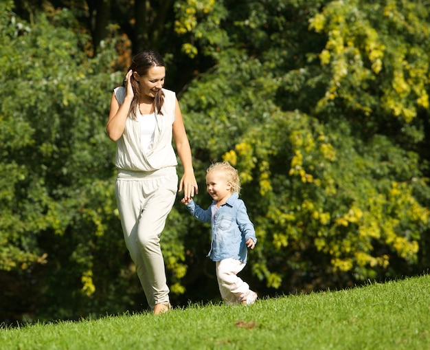 Mother walking outdoors with baby