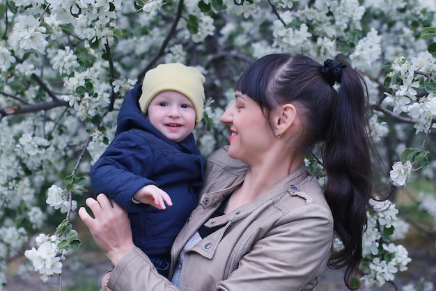 Mother with baby in apple garden