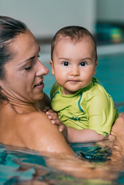 Mother with baby boy in the swimming pool