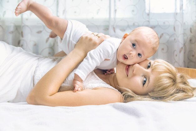 Mother with baby on a light background. Selective focus. People.