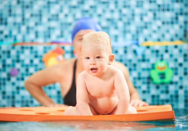 Mother with baby in swimming pool training