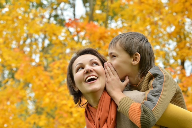 Mother with boy on walk in autumn park