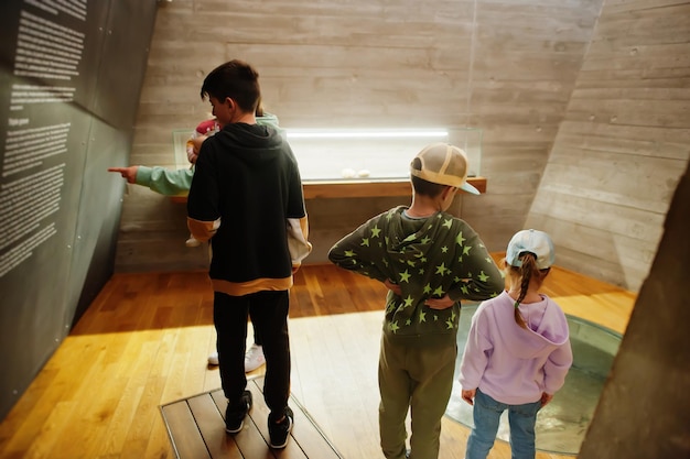 Mother with children exploring expositions in museum halls